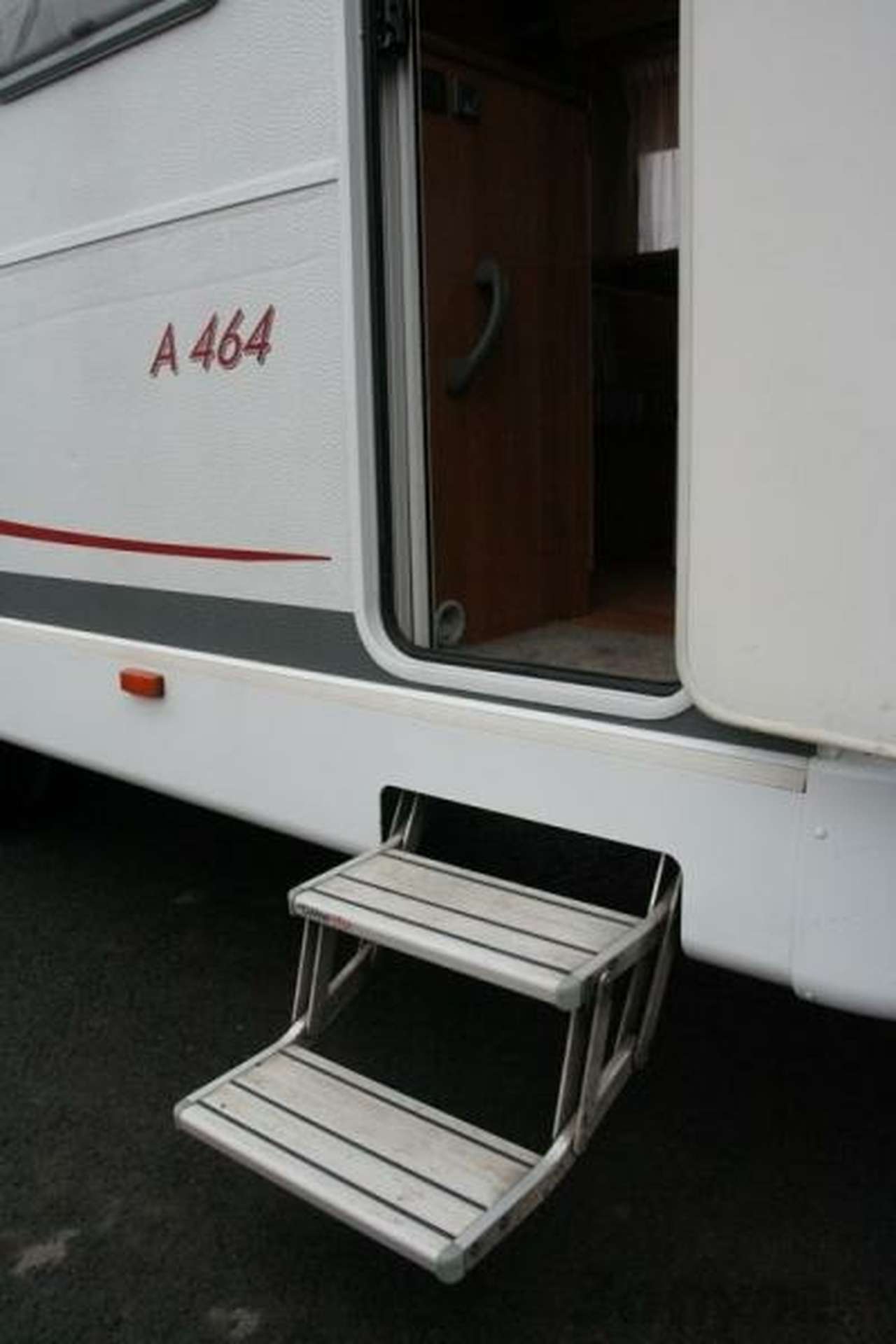 Под входной дверью расположена ступенька с электроприводом. Клавиша – управления рядом со входом.