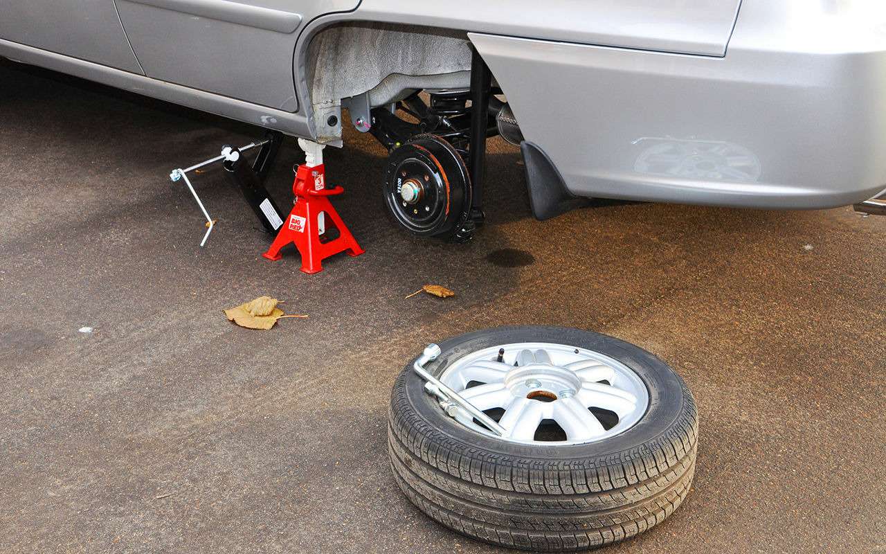 Если пользоваться штатным домкратом, то лучше для страховки подставлять под автомобиль специальную стойку. Ну или хотя бы подложить запасное колесо так, чтобы при падении порог лег на колесный диск, а не на шину. Учтите, что при этом диск скорее всего повредится. Поэтому лучше использовать старое ненужное колесо.